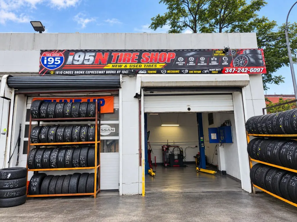 i95N Tire Shop on the Cross Bronx Expressway, with its sign, open service bay and racks of tires